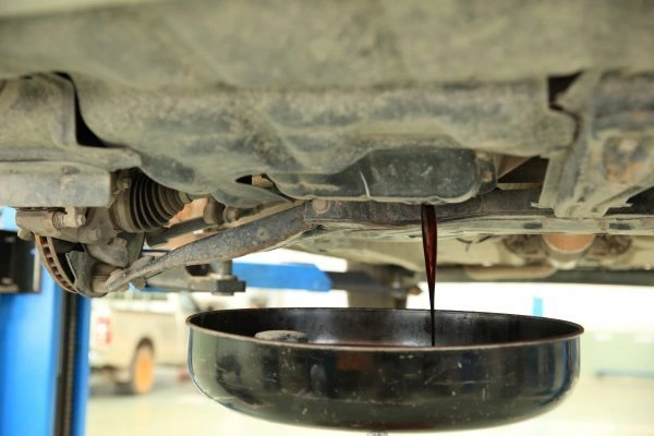 Engine Oil Draining Into A Pan