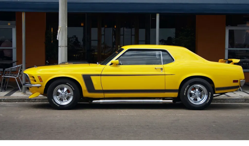 Yellow 1970 Mustang with side pipes
