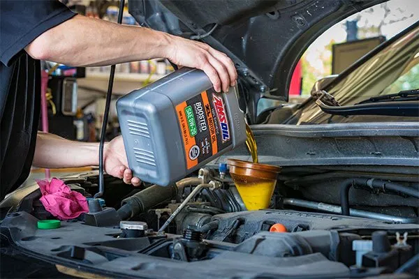 Pouring AMSOIL XL Synthetic Motor Oil